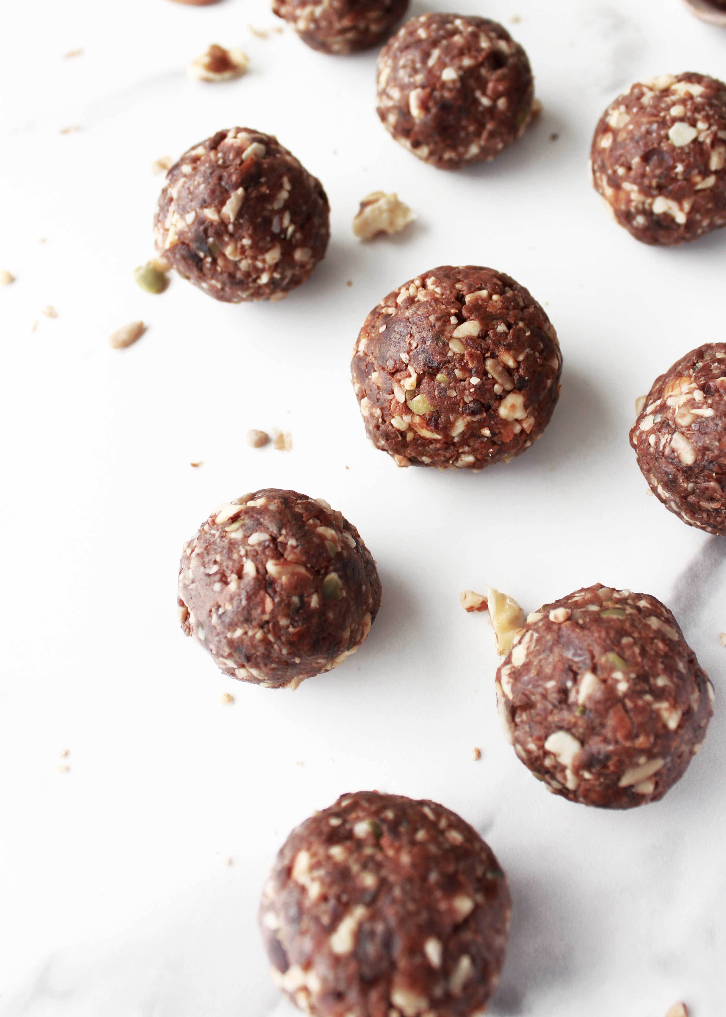 Chocolate nut and cacao seed vegan protein balls with peanut butter, almonds and gluten free, refined sugar free ingredients for a helathy plantbased high protein snack