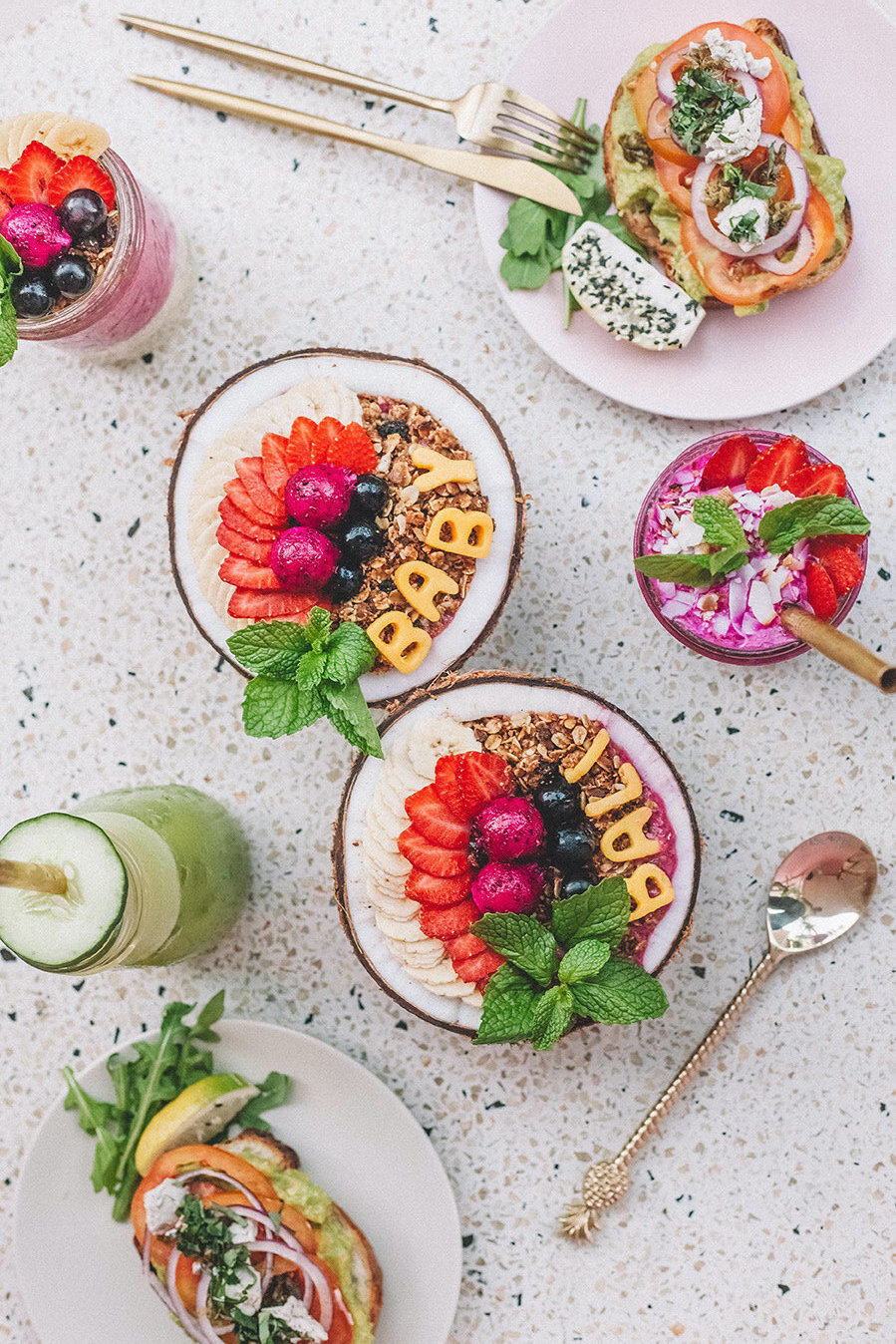 Brunch spread of açai bowls, avocado toast, smoothie bowls at Kynd Community cafe in Bali. Cafe voucher as a gift ideas for foodies