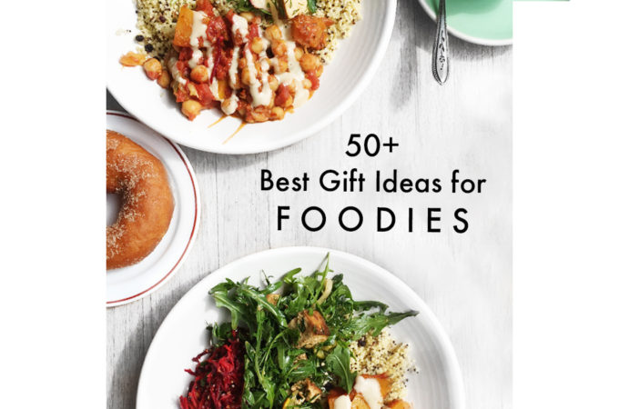Text reading Best gift ideas for foodies in 2021 on a flatlay of colourful burrito salad bowls, donut and coffee at a cafe table