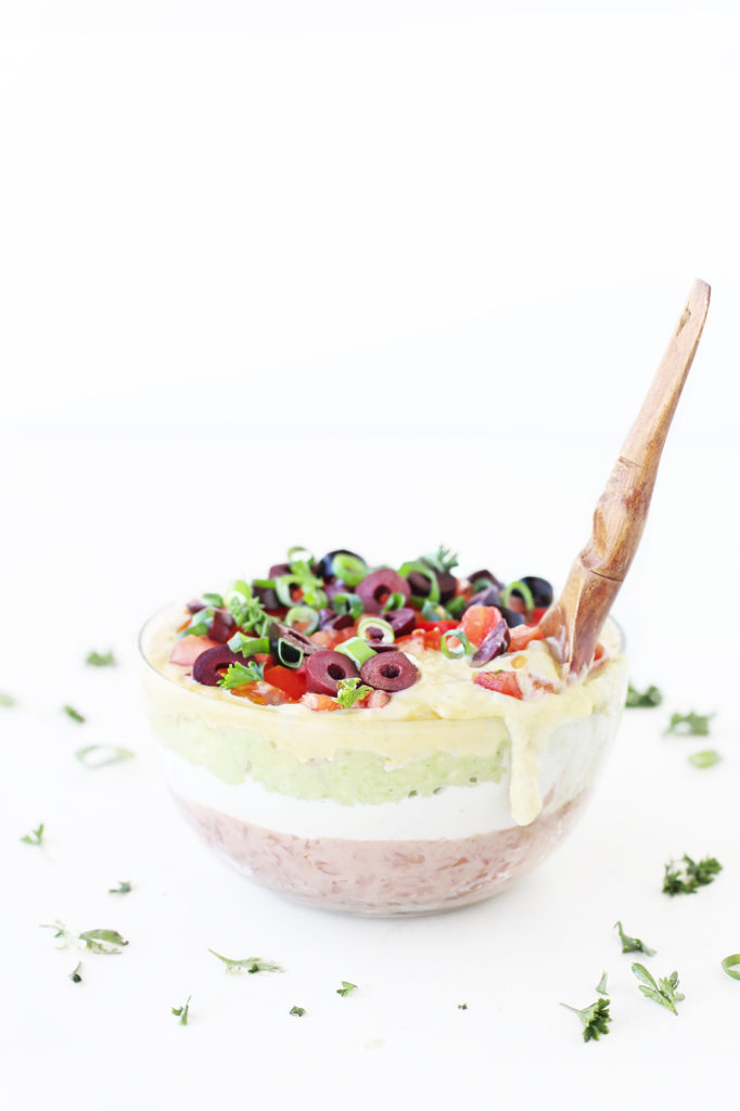 gluten free dairy free vegan queso guacamole sour cream and oil free refried beans into a mexican layered ( 7 layer dip for a colourful new years eve recipe 