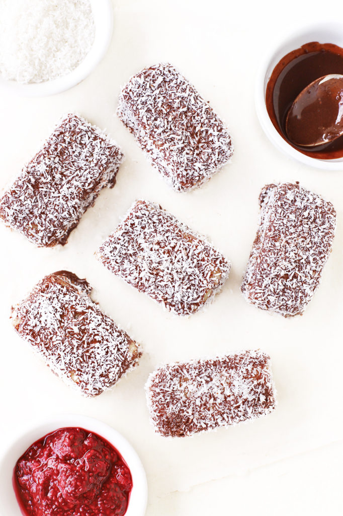 No-bake vanilla sponge cake bites layered with raspberry chia jam, coated in vegan, dairy free chocolate and covered in desiccated coconut to represent the classic Australian lamington recipe