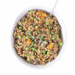 Creamy mushroom risotto with pumpkin, peas and quinoa for one of the best, healthy dinner recipes (without white wine). An easy plant based meal with vegetables topped with nutritional yeast dairy free parmesan